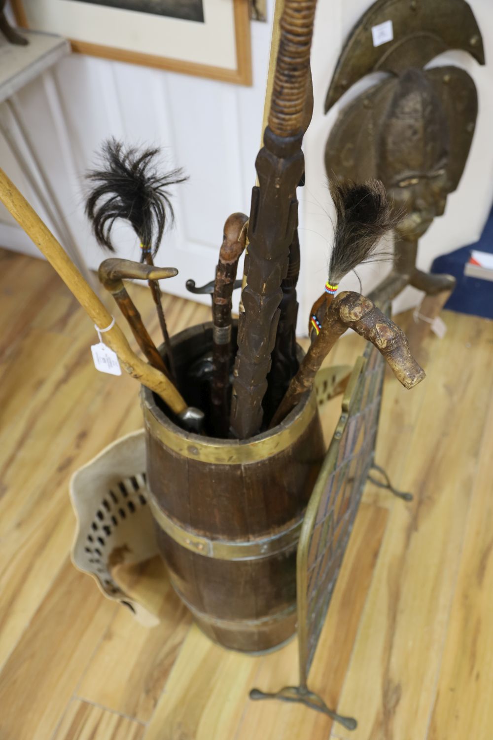 A brass bound coopered oak stickstand, assorted sticks a firescreen etc